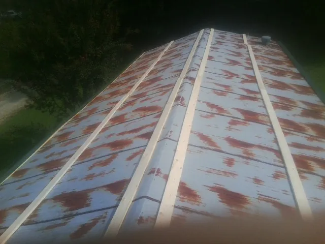 Rusted metal roof panels with new wood purlins before replacement — Storm Damage Roof Repair in Lurgan by Roofing Brothers