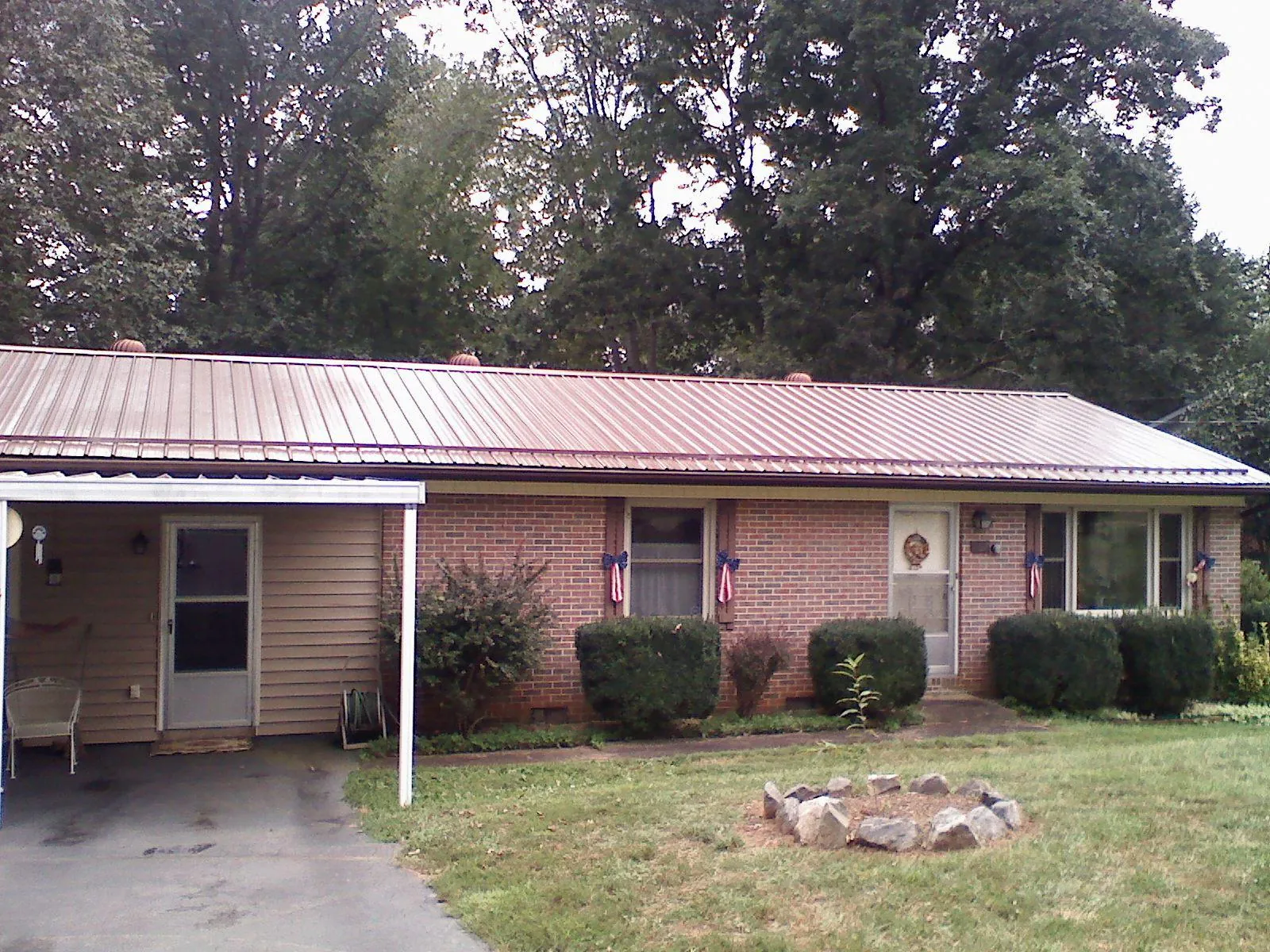 Bronze metal roof and carport on a brick ranch home — Roof Repair work by our crew in Lurgan