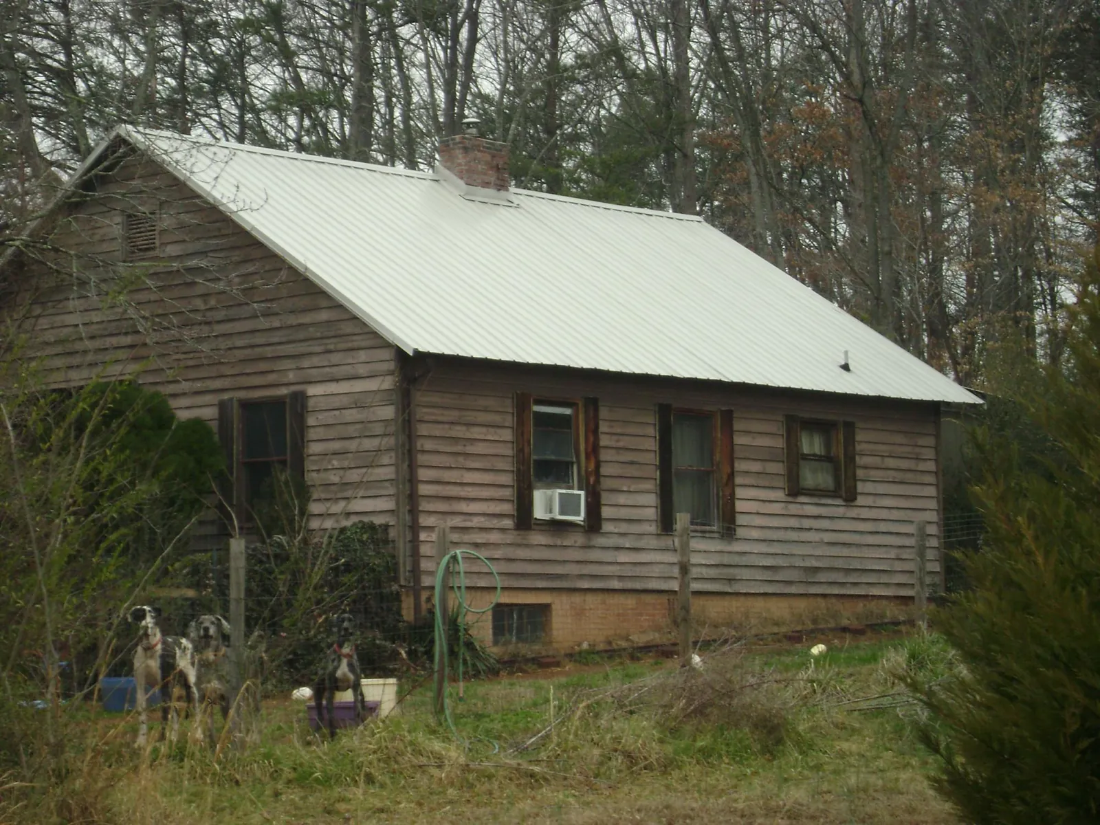 White metal roof on an old wood sided farmhouse, from a Asphalt Shingle Roof Repair job in Lurgan